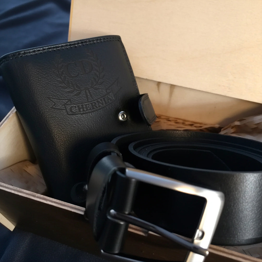 Personalized black leather wallet with embossed initials and a matching leather belt gift set for men