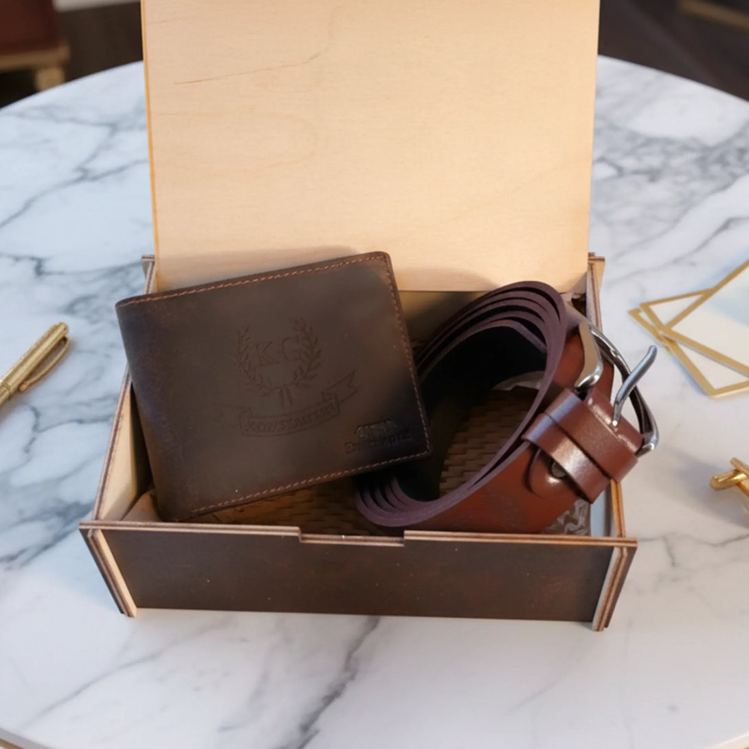 Personalized leather wallet and brown leather belt gift set for men in wooden box on marble table